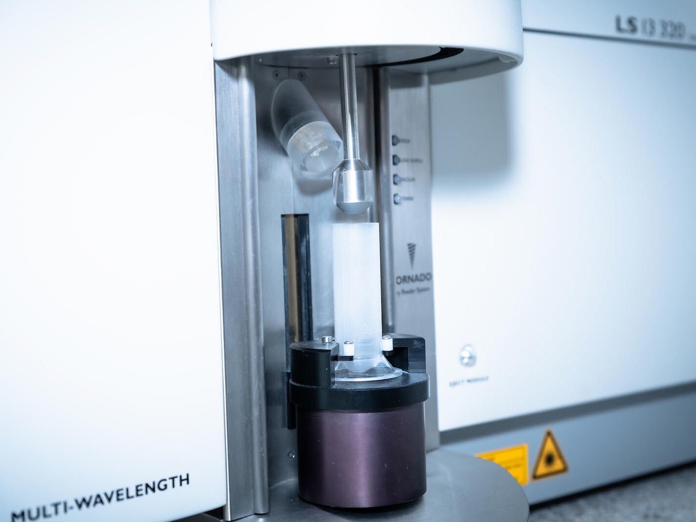Multi-wavelength spectrometer optics with laser illumination head in laboratory equipment close-up